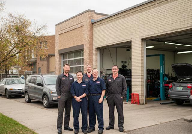 Mechanics standing outside a busy automotive repair shop on Elm Street in Winnipeg